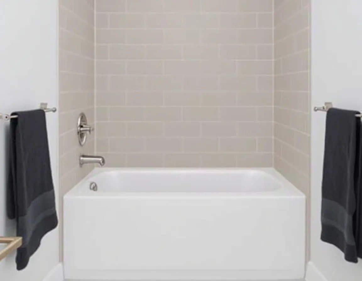 New alcove bathtub with a neutral tile surround